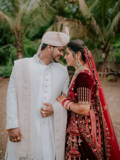 A beautiful, smiling portrait of the couple looking at each other during their reception.