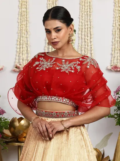 Another close-up of the red cape blouse, capturing its delicate and ethereal quality.