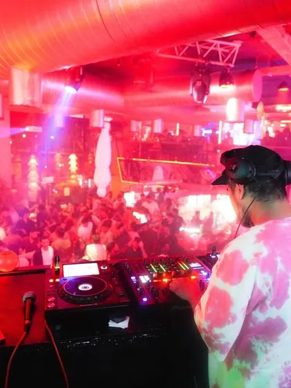 A view from my perspective at BOHO, with the club lit up in red and the dance floor completely packed. Every night is an opportunity to create a memorable experience.