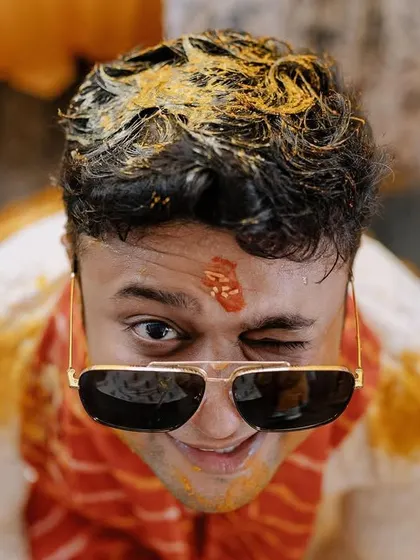 A playful wink from the groom during his Haldi. I always look for these little moments of personality that make your photos unique.