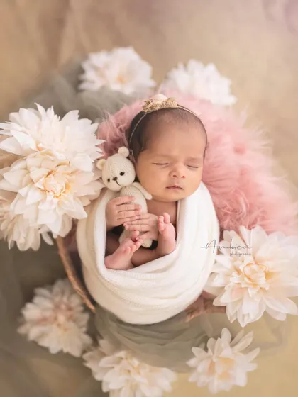 The pure, peaceful sleep of a newborn is a fleeting moment. I designed this cozy, floral setup to capture that serenity, focusing on the delicate details that make your baby unique.