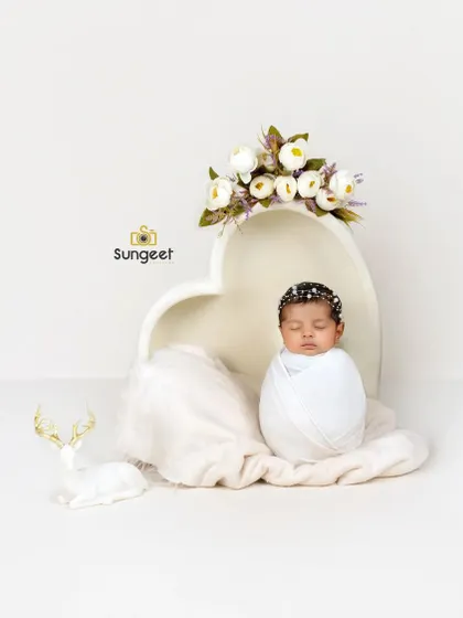 A classic potato sack pose in our heart-shaped bowl. This pose is perfect for showing off a newborn's sweet, curled-up form in a simple and beautiful way.
