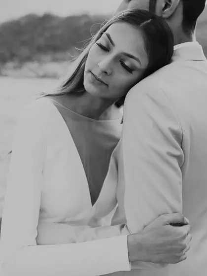 A serene and elegant black and white portrait from a pre-wedding shoot in Kashmir. The focus is on the quiet emotion and connection, set against a backdrop of natural beauty.
