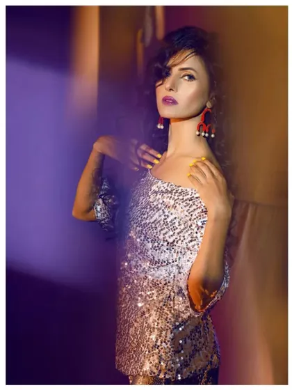 A creative, artistic shot highlighting the texture and shine of the silver sequin top. This kind of party wear is designed to catch the light and turn heads.