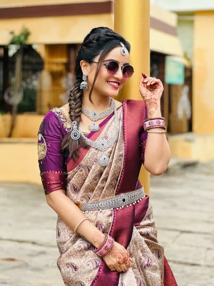 A client looking stylish in a silver-finish CZ stone necklace set, complete with a matching vaddanam. This look is perfect for a modern wedding reception.