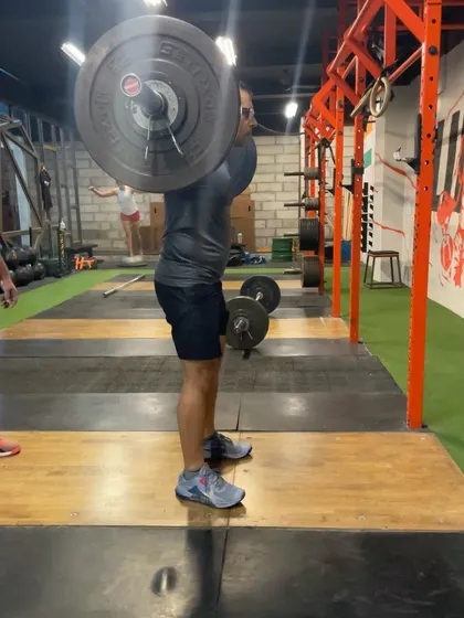 This athlete is practicing the drop snatch to improve his speed under the bar. It's a technical drill that pays huge dividends in lifting heavier weights.