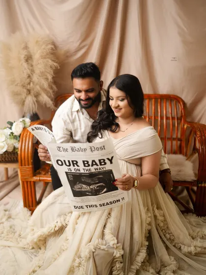 Reading the big news together. This creative shot with "The Baby Post" newspaper is a fun and memorable part of their boho maternity session.