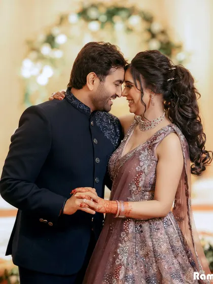 A joyful and intimate portrait of a couple on their engagement day. Their genuine smiles and foreheads touching create a picture of pure happiness and love.