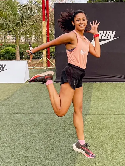 Embracing the wind and soaring with grace. A joyful jump at a Nike training event, celebrating the feeling of being fit and strong.