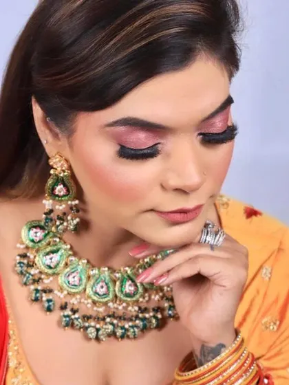 A shot focusing on the eye makeup with eyes closed. The pink shimmer eyeshadow is expertly blended, showing the detail and precision in my work for occasion makeup.