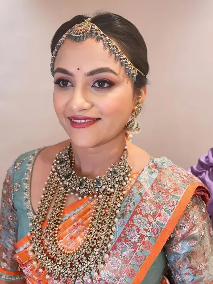 A final look at this bride's stunning ensemble. The makeup is soft and glowing, a perfect match for her ornate jewelry and beautiful silk saree.