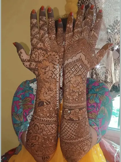 A bride showcasing her beautiful and unique mehendi, which features a mix of patterns and styles.