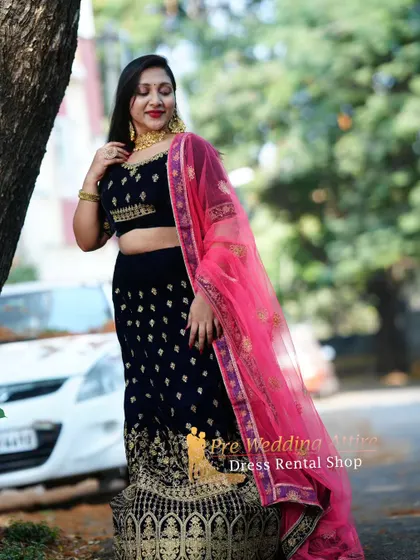 Another angle of the blue velvet lehenga, showing the detailed work on the blouse and the flow of the dupatta.