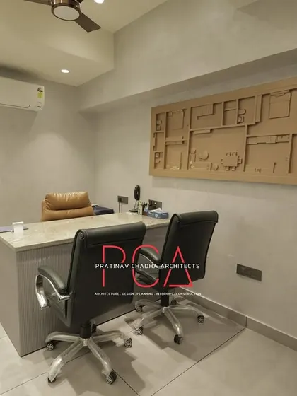 A private office cabin at StyleIn Homes, featuring a custom 3D wall art piece depicting a floor plan, adding a unique architectural touch to the space.