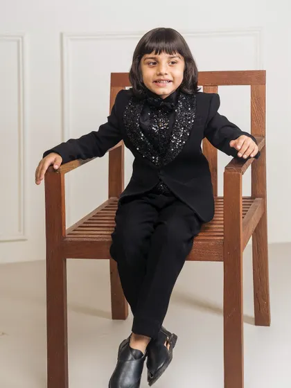 Another view of the black tuxedo with the sparkling sequin cowl neck. This design is a great option for a boy's birthday party or a New Year's Eve event.