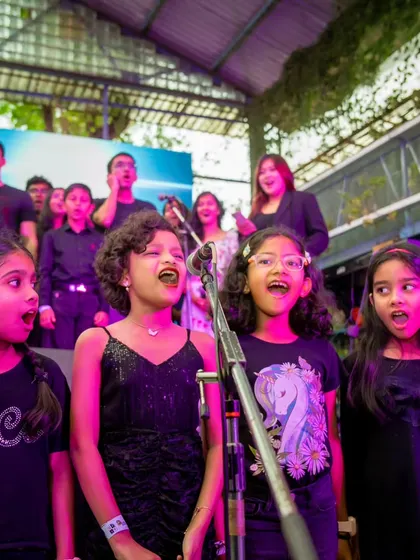 Our junior choir singing with passion at the showcase. We believe in giving every student, no matter their age, the confidence to perform.