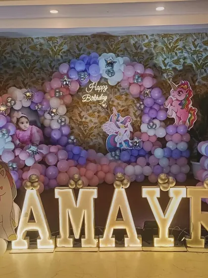 A 'My Little Pony' and unicorn theme for Aamyra's first birthday. The pastel balloon arch and large light-up letters create a dreamy photo corner.