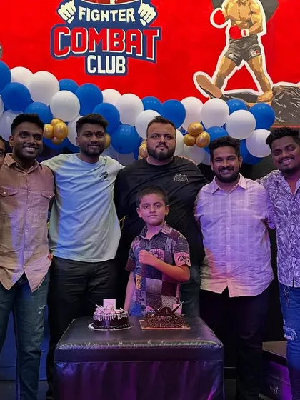 Celebrating a birthday with cake and the team. These moments build the family atmosphere that defines Fighter Combat Club.