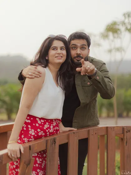 A fun, spontaneous moment on a wooden bridge. Capturing your unique personalities and the fun you have together is a key part of our process.