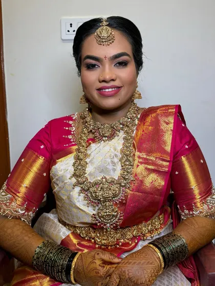 A smiling portrait of Harshitha. The HD makeup ensures she looks flawless both in person and on camera, without hiding her beautiful features.