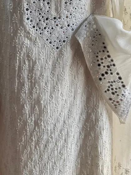 A detail shot of the sleeve and side panel, showing the intricate placement of mirrors.