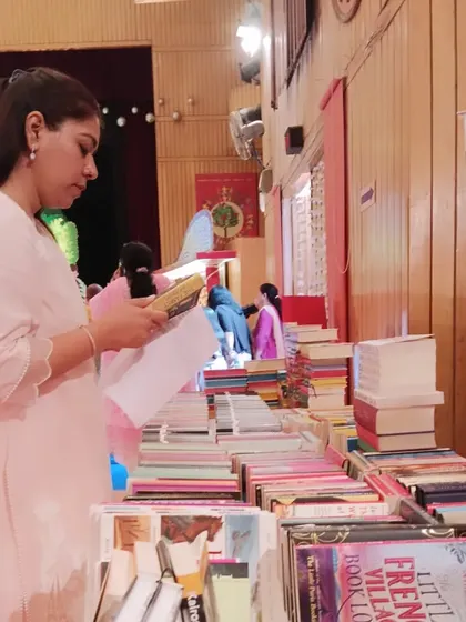 A parent thoughtfully browses the books at our stall. School fairs are a great opportunity for us to connect with the wider community of parents and educators.