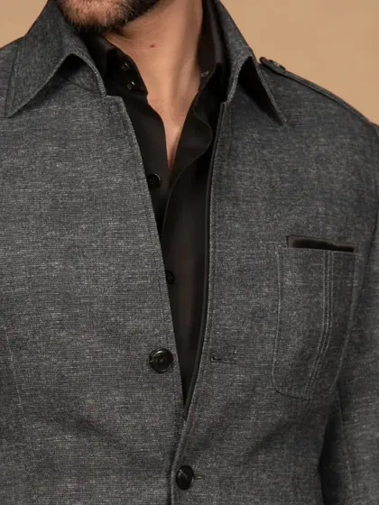 A close-up of my summer shacket in a textured grey fabric. It's the perfect blend of a shirt and a jacket, ideal for effortless summer layering and a casual chic look.