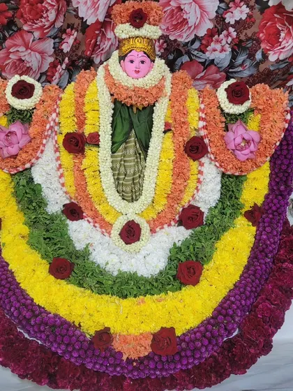 A beautiful alankaram of a Goddess idol, decorated with colorful flower garlands.