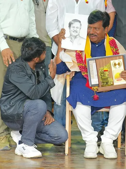 Kneeling to present a sketch to a respected guest at a cultural program. I believe in showing respect for elders and fellow artists, as is our tradition.