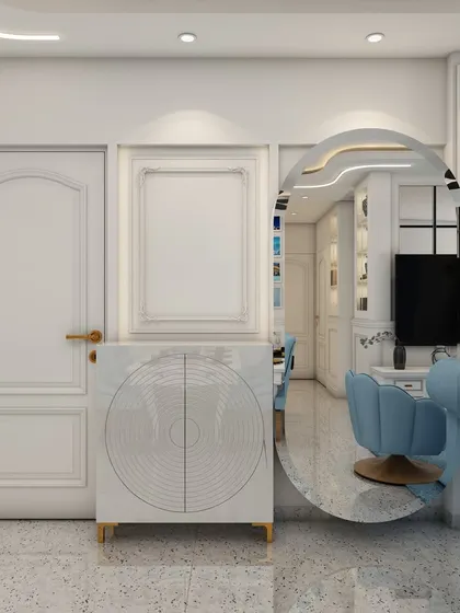 A detail shot from the blue living room, focusing on the entryway with a unique circular cabinet and a large oval mirror that adds a touch of modern artistry.