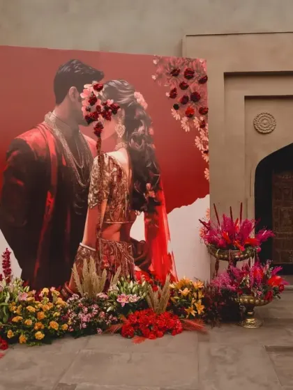 A personalized photo backdrop featuring a stunning portrait of the couple and their names in both Hindi and Arabic script. This element beautifully celebrated the union of two cultures.