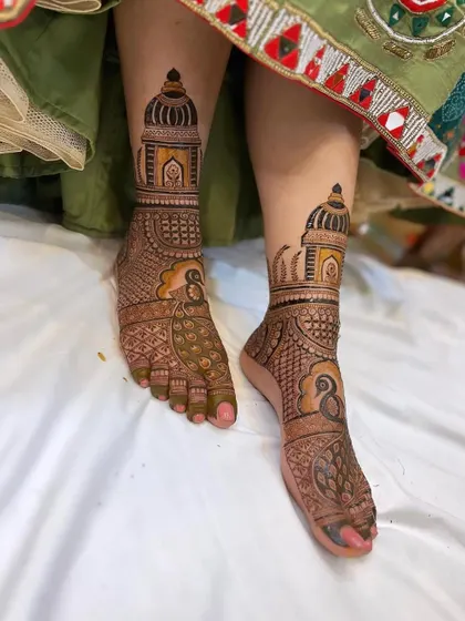 A striking foot mehandi design with bold peacock figures and architectural elements, perfect for making a statement.