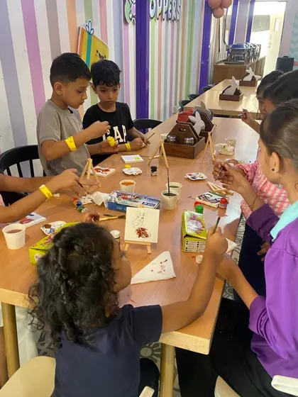 Another view of our art room, where kids are busy painting on mini canvases with easels, just like real artists.