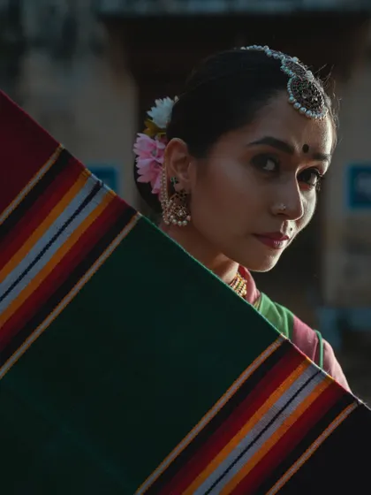 A close-up from a collaboration focused on the revival of the Jamakalam rug. The textures of the fabric and the dancer's expression are woven together.
