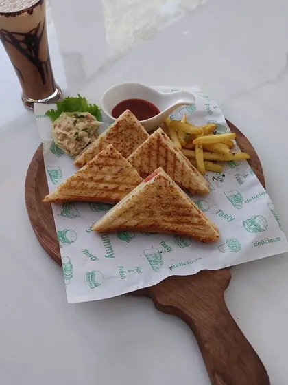 Another angle of our sandwich and cold coffee combo, presented on a rustic wooden board.