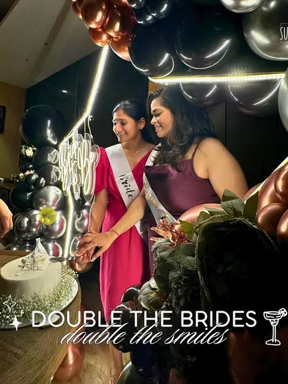 Double the brides, double the smiles! We had so much fun creating this joint bachelorette party setup. The brides are seen here cutting their cake in front of our custom balloon arch.