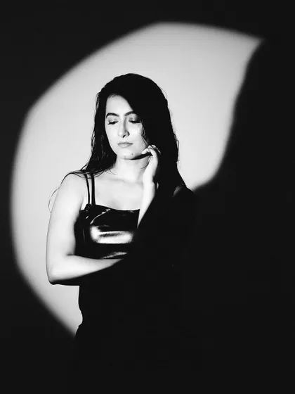 A moody and artistic black and white shot using a spotlight. The deep shadows and bright highlight create a sense of mystery and drama.