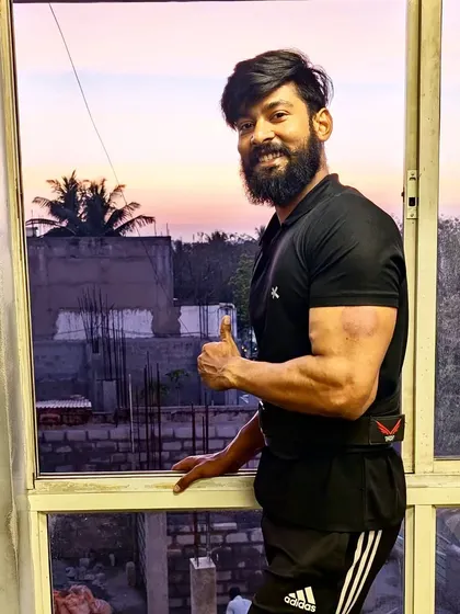 A thumbs-up for progress. A post-workout photo showing a satisfying arm pump.