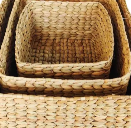 A set of three nesting baskets, woven from natural water hyacinth. These square baskets are perfect for modular storage, allowing you to organize shelves and cupboards with a touch of natural, coordinated style.