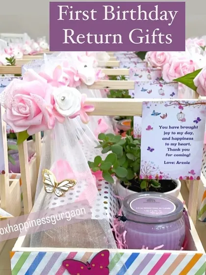 A close-up of a first birthday return gift basket, decorated with pink flowers, butterflies, and a sweet thank you card from the birthday girl.