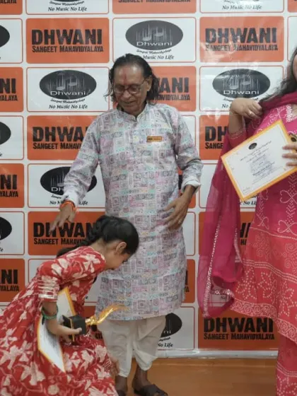 A young student touches her guru's feet, a sign of deep respect in the Guru-Shishya tradition.