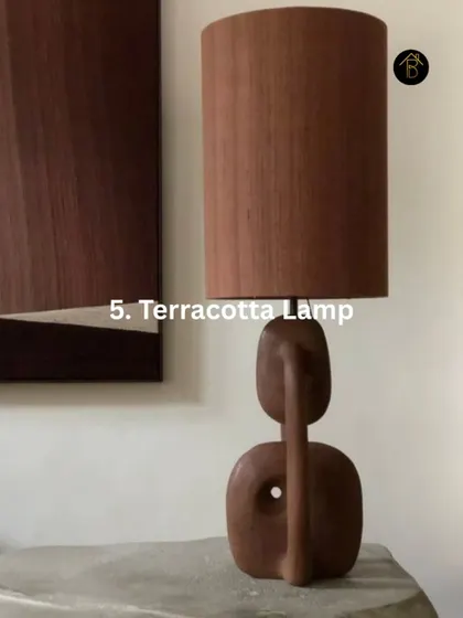 A terracotta lamp is a perfect brown accent piece. Its earthy material and sculptural form can add an artistic, warm touch to any corner.