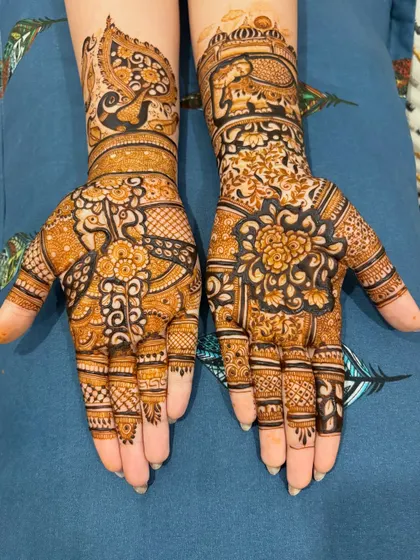 This design combines floral mandalas with peacock and elephant motifs. The mix of bold and fine lines creates a balanced and visually appealing look.