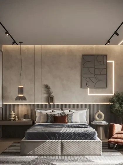 This room features an industrial-chic aesthetic with track lighting and a concrete-finish accent wall. The comfortable recliner and warm accent lighting create a cozy corner for relaxation within the modern space.