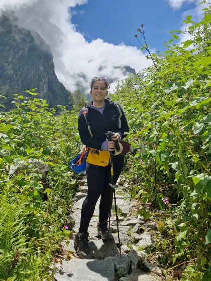 Pausing on a narrow stone path during my trek. The journey was challenging, but moments like these, surrounded by the immense beauty of the Himalayas, made it all worth it.