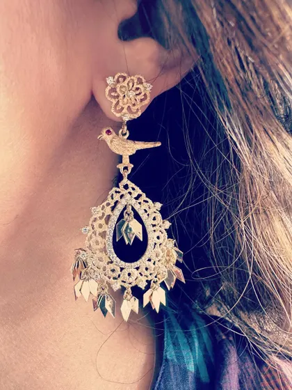 The "Birds of Paradise" earrings. These are designed to be lightweight and breezy, featuring a mix of matte and mirror finish 18k gold with a bird motif, creating a fun and playful piece.