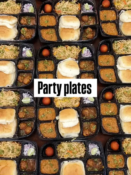 Pav, noodles, curry and gulab jamun sit in separate compartments across the party plates we prepared.