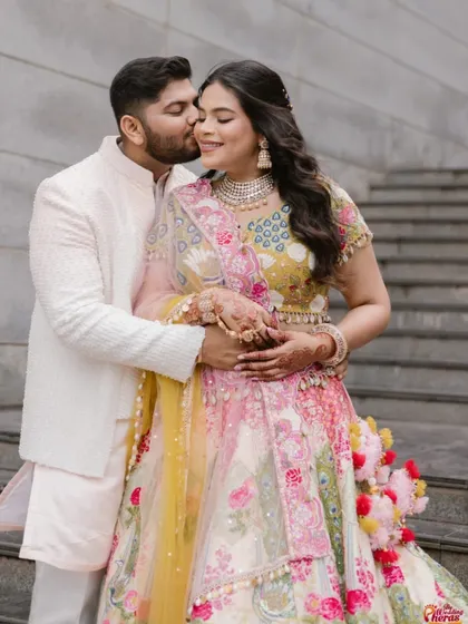 A sweet moment between the couple during a pre-wedding ceremony. Her makeup is soft and romantic.