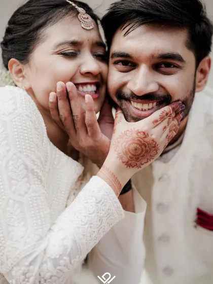 A genuinely happy and candid moment, with the bride playfully squishing the groom's cheeks. These are the unposed memories I love to capture.