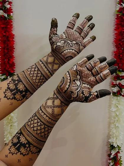 A full-arm design with a festive background. The patterns include lotus motifs and traditional check designs for a classic bridal feel.